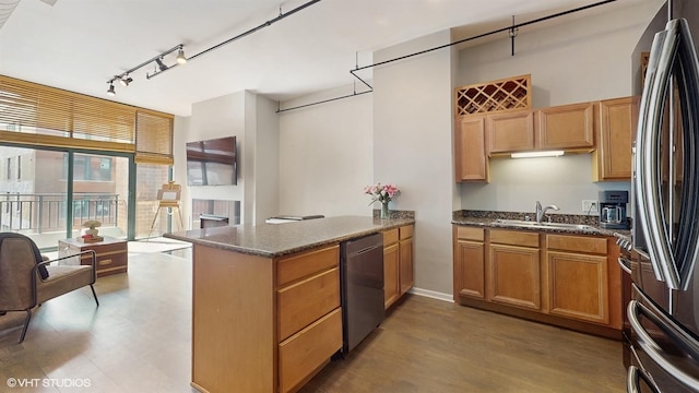 400 W Ontario St Unit 606, Chicago, IL 60654 - kitchen with dark stone counters, rail lighting, a peninsula, a sink, and stainless steel appliances