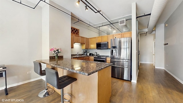 400 W Ontario St Unit 606, Chicago, IL 60654 - kitchen featuring visible vents, dark wood-style floors, a towering ceiling, and stainless steel appliances