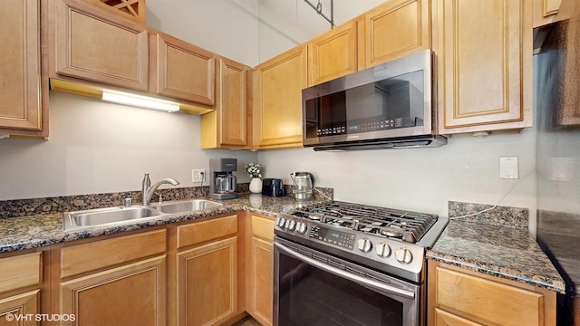 400 W Ontario St Unit 606, Chicago, IL 60654 - kitchen featuring stainless steel appliances, light brown cabinetry, a sink, and dark stone counters