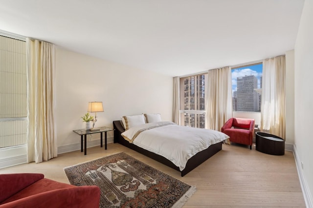 bedroom featuring wood finished floors and baseboards