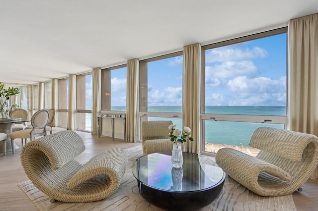 sunroom / solarium featuring a water view