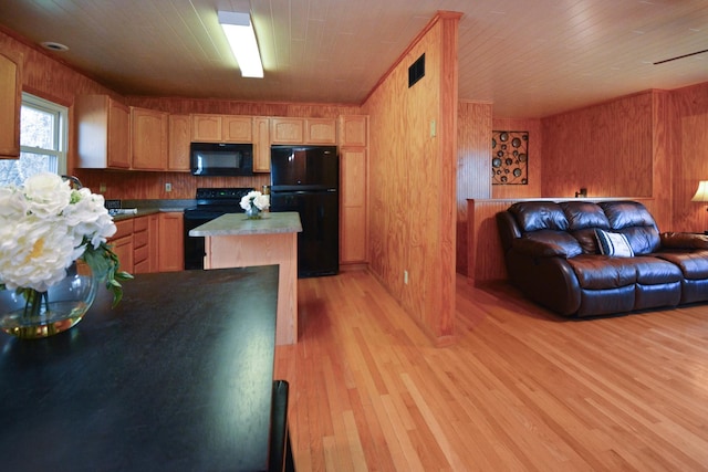 kitchen with open floor plan, black appliances, visible vents, and light wood-type flooring