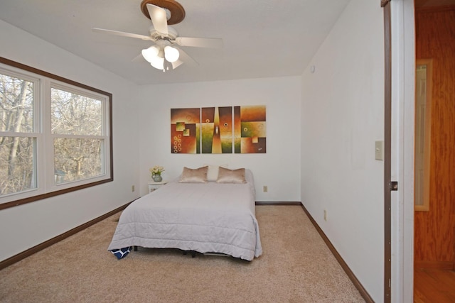 bedroom with a ceiling fan, carpet, and baseboards