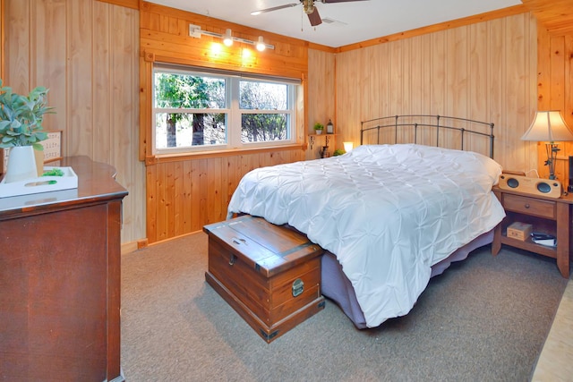 bedroom with carpet floors, ceiling fan, and wooden walls