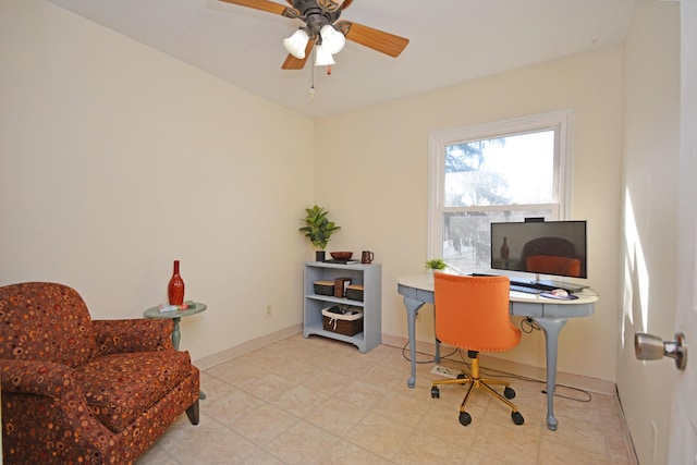 home office featuring a ceiling fan and baseboards
