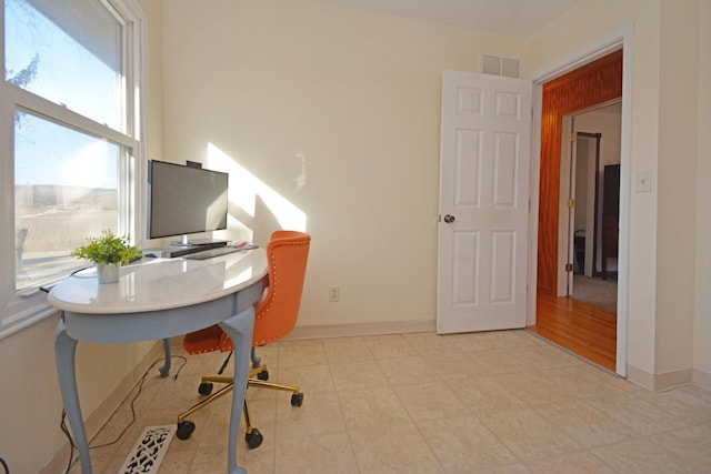 home office with baseboards and visible vents