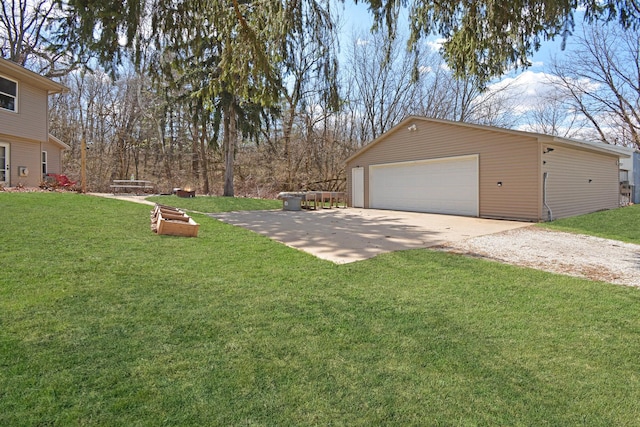 view of yard featuring an outbuilding, driveway, and a garage