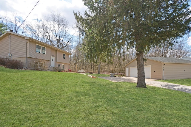 view of yard with driveway, an outdoor structure, and a garage