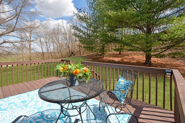 wooden terrace with a lawn