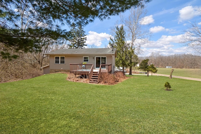 back of property with a lawn and a deck