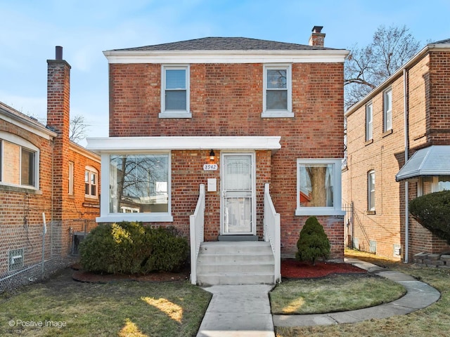 view of front of property with brick siding and a chimney