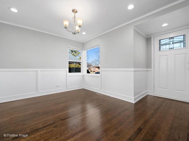 interior space with a wainscoted wall, a notable chandelier, ornamental molding, wood finished floors, and recessed lighting
