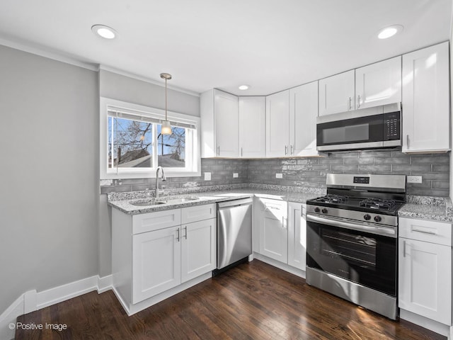 kitchen featuring a sink, light stone counters, tasteful backsplash, and appliances with stainless steel finishes