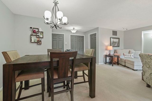 326 Park Ave Unit 38, Clarendon Hills, IL 60514 - dining area featuring light colored carpet, a chandelier, and baseboards