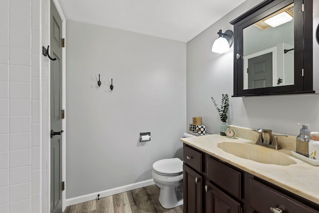 326 Park Ave Unit 38, Clarendon Hills, IL 60514 - bathroom featuring toilet, vanity, wood finished floors, and baseboards