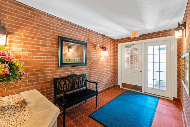 326 Park Ave Unit 38, Clarendon Hills, IL 60514 - tiled entryway with brick wall, a textured ceiling, and baseboards