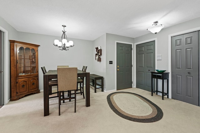 326 Park Ave Unit 38, Clarendon Hills, IL 60514 - dining area featuring light colored carpet, a chandelier, a textured ceiling, and baseboards
