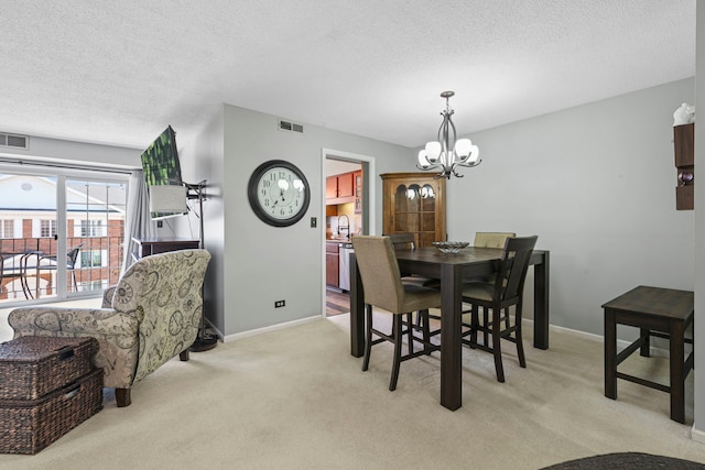 326 Park Ave Unit 38, Clarendon Hills, IL 60514 - dining area with a chandelier, a textured ceiling, light carpet, and baseboards