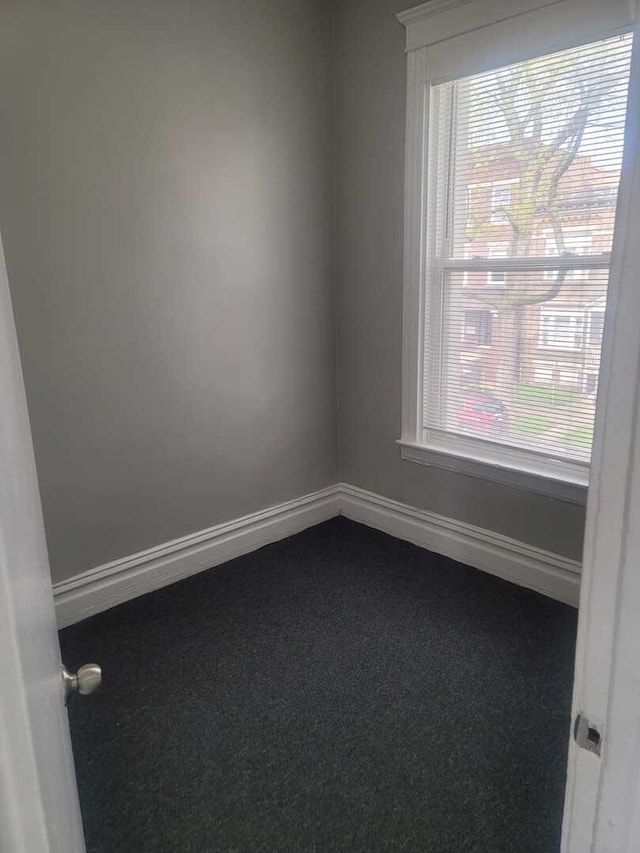 6506 S Eberhart Ave, Chicago, IL 60637 - empty room with baseboards, dark colored carpet, and a healthy amount of sunlight