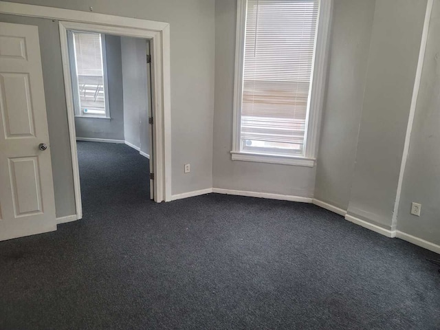 6506 S Eberhart Ave, Chicago, IL 60637 - spare room featuring baseboards and dark carpet