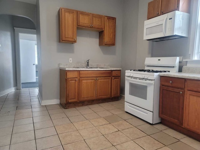 6506 S Eberhart Ave, Chicago, IL 60637 - kitchen featuring brown cabinets, white appliances, light countertops, and a sink