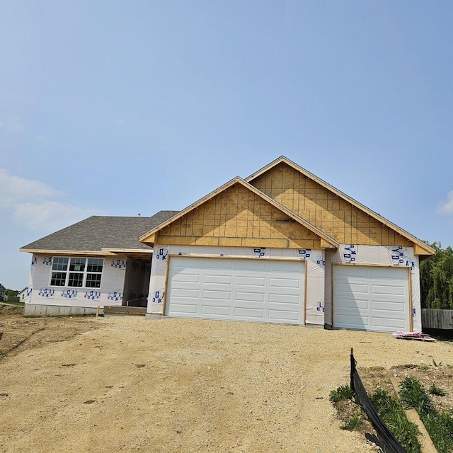 12620 New York St, Loves Park, IL 61111 - unfinished property with driveway, an attached garage, and roof with shingles