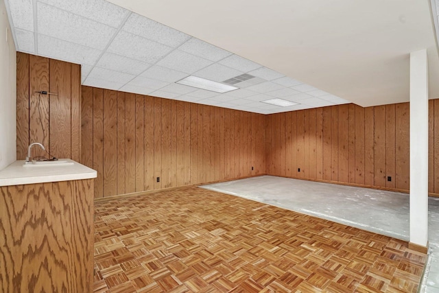 218 San Carlos Rd, Minooka, IL 60447 - unfurnished room with baseboards, wood walls, and a drop ceiling