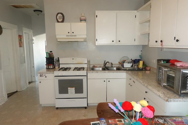 3801 W 46th St, Chicago, IL 60632 - kitchen with light countertops, white range with gas cooktop, under cabinet range hood, white cabinets, and a sink