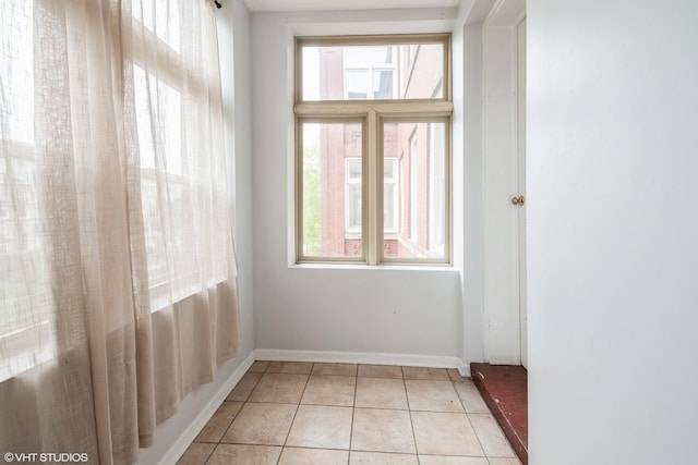 1516 E Marquette Rd Unit 2E, Chicago, IL 60637 - empty room with a wealth of natural light, baseboards, and light tile patterned flooring