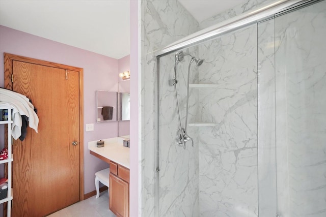 full bath featuring vanity and a marble finish shower