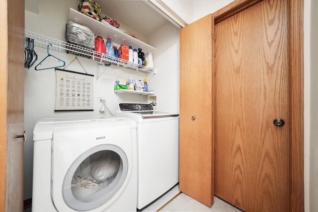 laundry room with washing machine and clothes dryer and laundry area