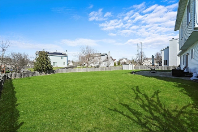 view of yard with a fenced backyard and a residential view