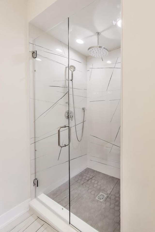 full bath with a shower stall, baseboards, and recessed lighting