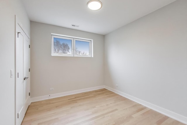 unfurnished bedroom with visible vents, light wood-type flooring, and baseboards