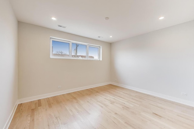empty room with baseboards, visible vents, light wood-style flooring, and recessed lighting