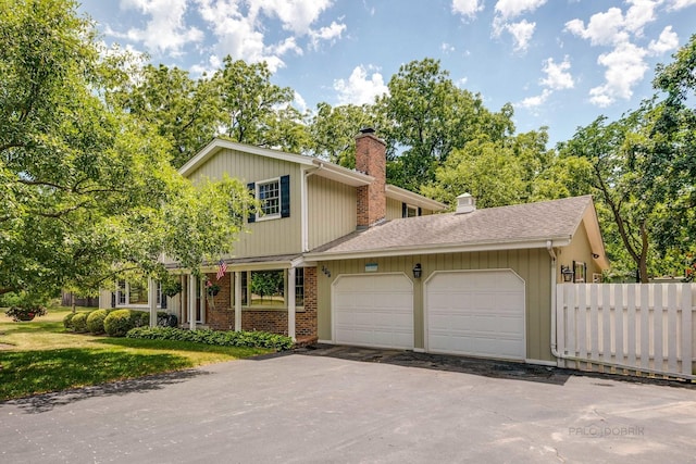 455 Hickory Haven Dr, Gurnee, IL 60031 - view of front of house featuring a chimney, an attached garage, driveway, brick siding, and a shingled roof