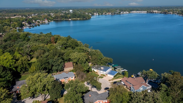 aerial view with a forest view and a water view