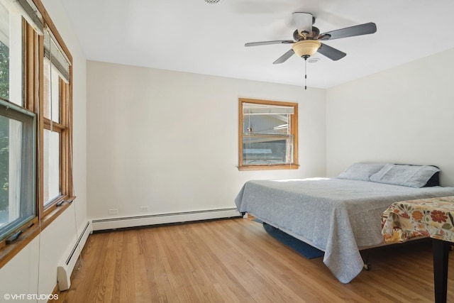 bedroom with baseboard heating, light wood-type flooring, and ceiling fan
