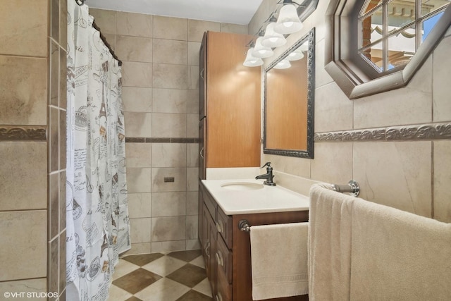 bathroom featuring tile walls, vanity, and a shower with curtain