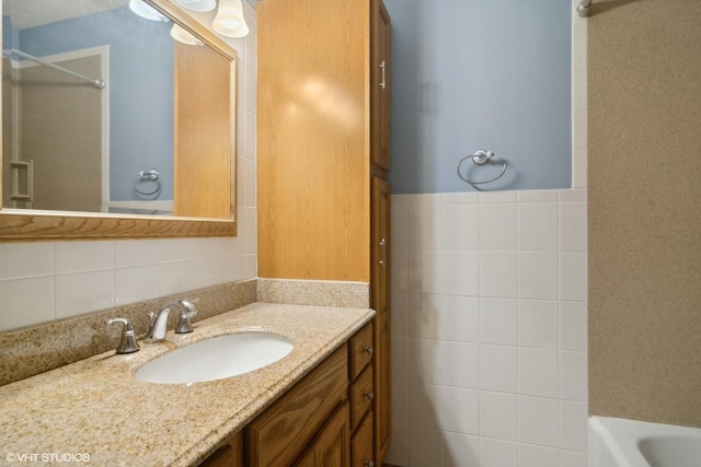 full bathroom featuring tile walls and vanity