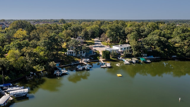 birds eye view of property featuring a forest view and a water view