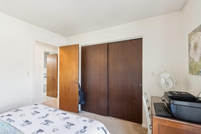 bedroom featuring a closet and light carpet