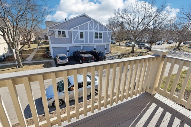 wooden deck with driveway and an attached garage