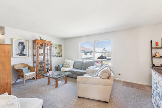 carpeted living room with baseboards