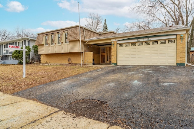 view of front of home featuring driveway and a garage