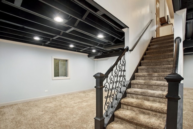stairs featuring carpet flooring and baseboards