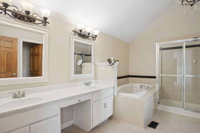 bathroom with a sink, lofted ceiling, a stall shower, and tile patterned floors