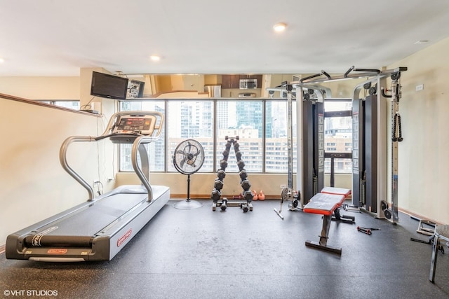 exercise room with baseboards and recessed lighting