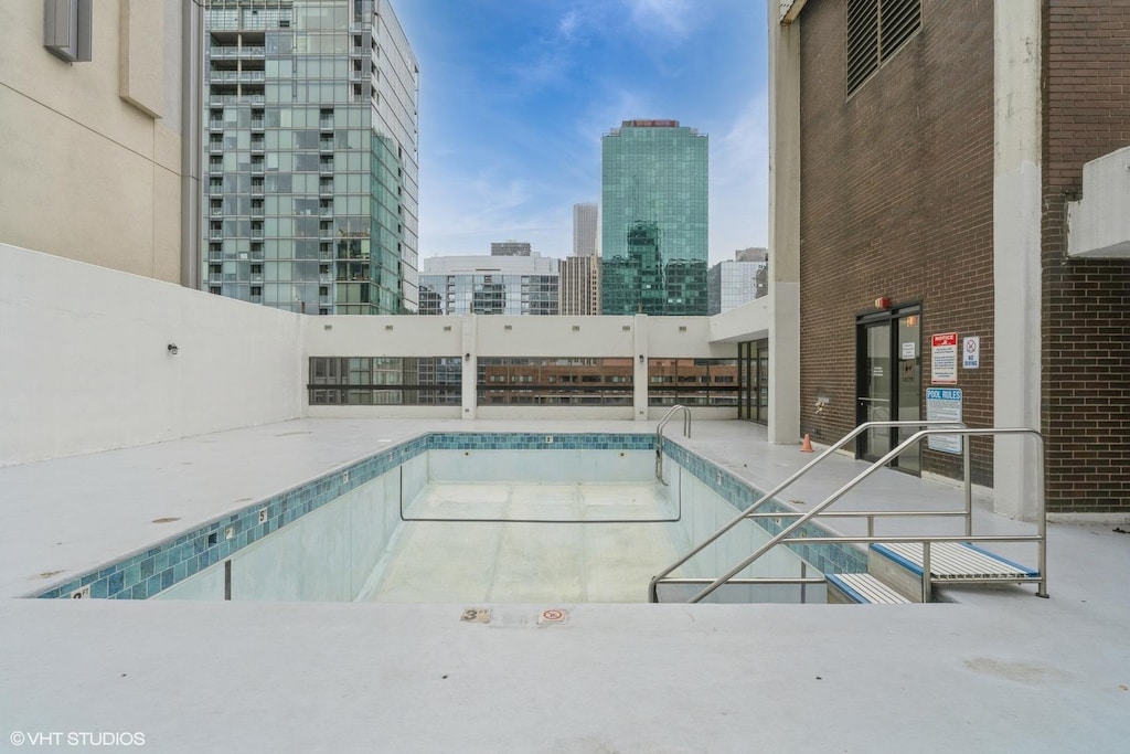 view of pool with a view of city