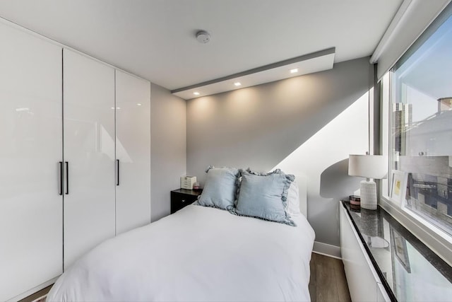 bedroom featuring dark wood-type flooring and recessed lighting